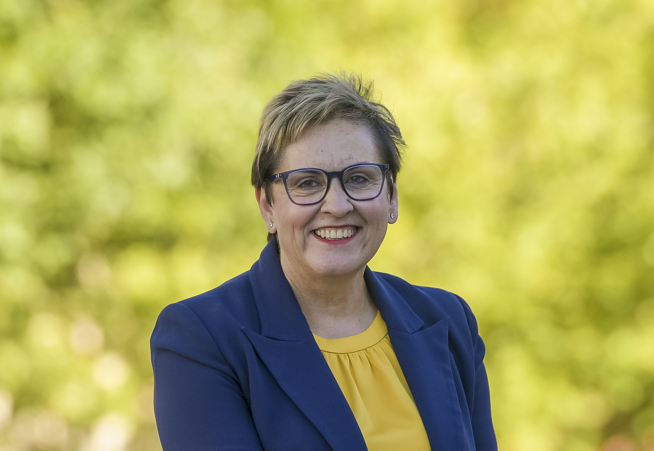 Erma Ranieri, Commissioner for Public Sector Employment, seated and smiling outdoors.
